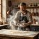 Portrait of savoury cook and pastry writer Marcus Hale dusting a wooden workbench with rye flour